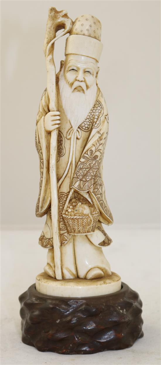 A Japanese ivory figure of a sage, early 20th century, height 25.5cm including wood stand